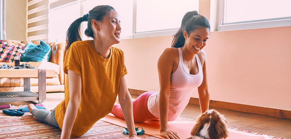 two ladies practicing yoga