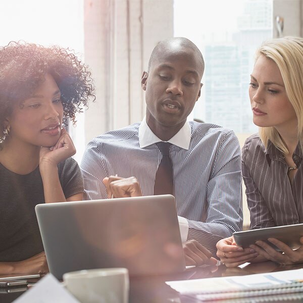 group of workers sitting in front of computer