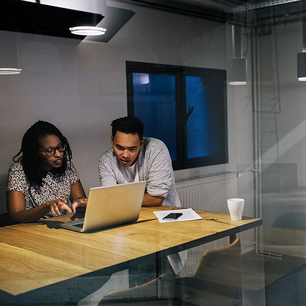 Man and woman looking at laptop