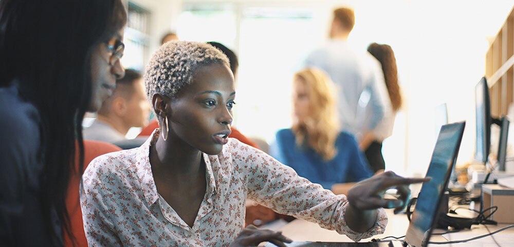 Woman seated in front of laptop