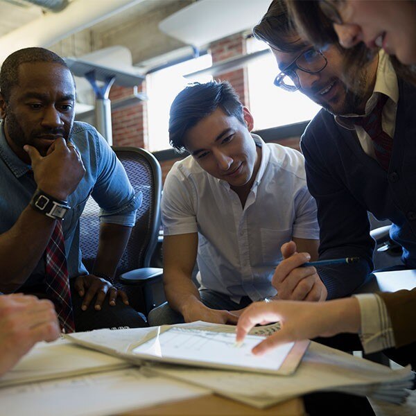 Colleagues gather around a tablet