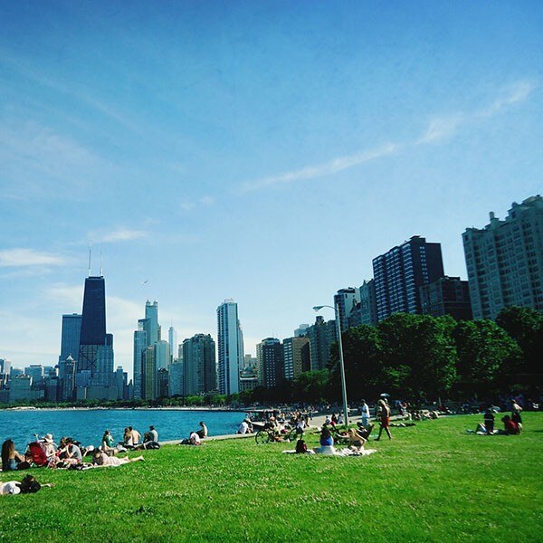 Chicago skyline and people lounging along Lake Michigan