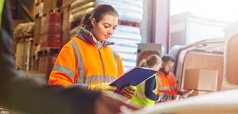 Female warehouse worker with clipboard