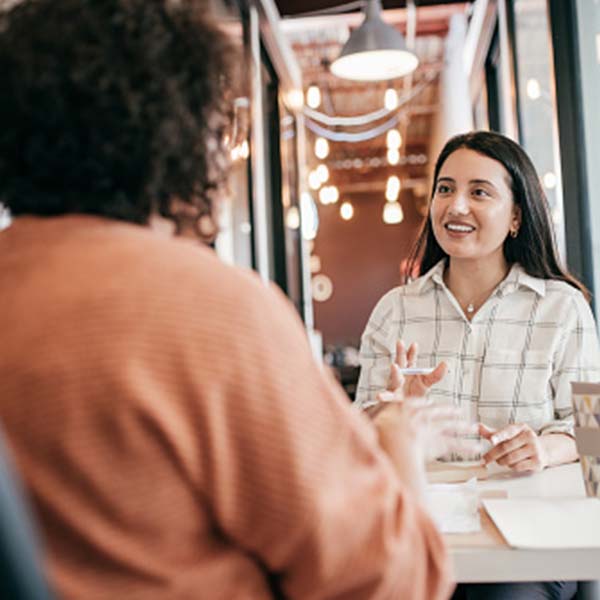 Two women interacting in a shop space