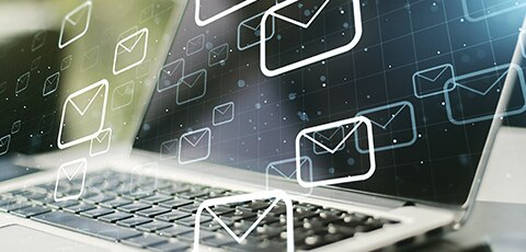 Laptop with overlay of email icons