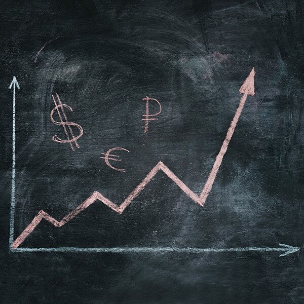 Line chart with currency symbols on blackboard