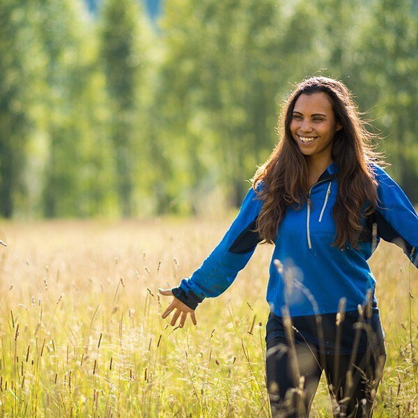 Native American woman walking through a field