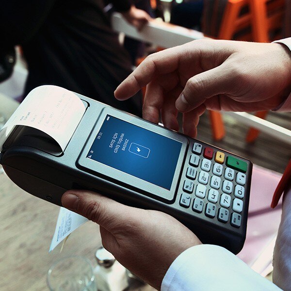 Waiter using hand held credit card reader