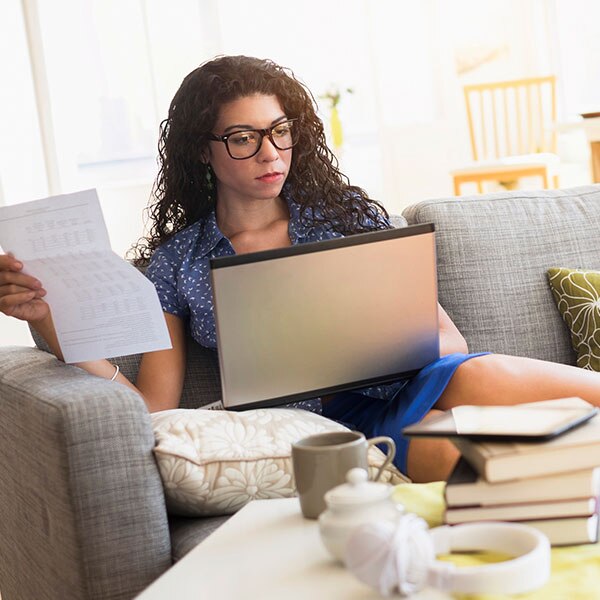 Woman sitting on a couch with a laptop
