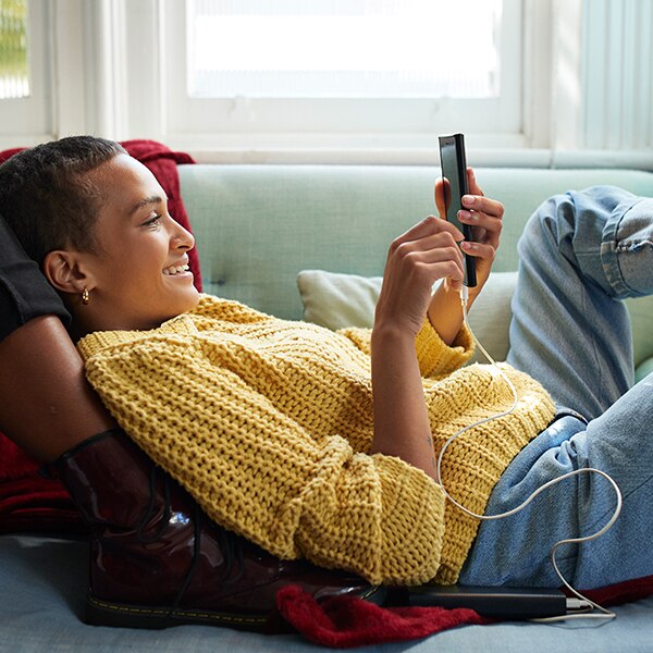 Woman relaxing while looking at her phone