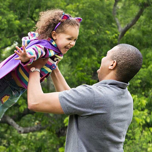 Father holding daughter overhead