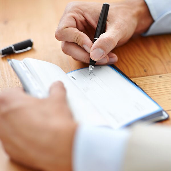 Person filling out a check