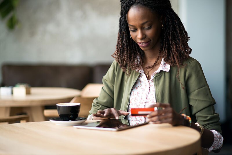 Woman using a tablet at a coffee shop