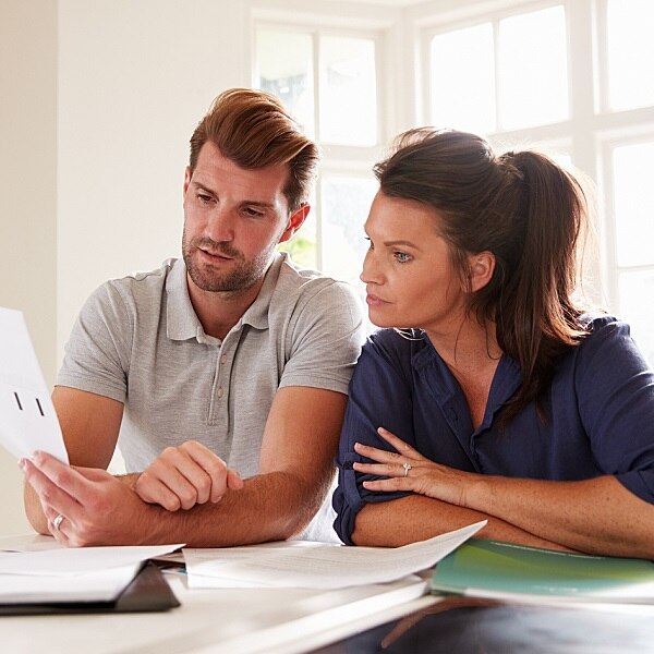 Man and Woman sitting at a table looking at papers