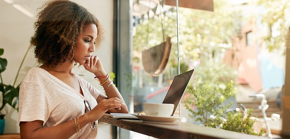 Woman using computer at a cafe