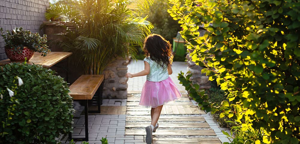 Girl running through garden