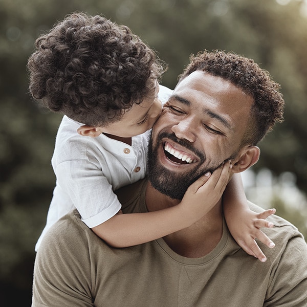 Child kissing father