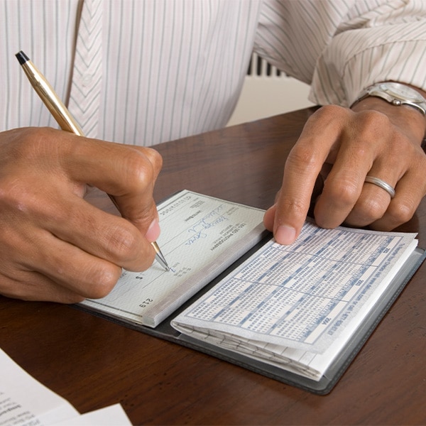 Person filling out a personal check
