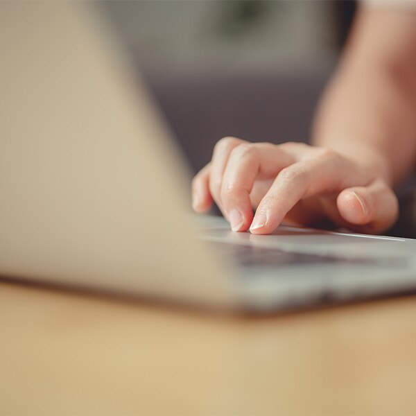 hand on laptop pressing key