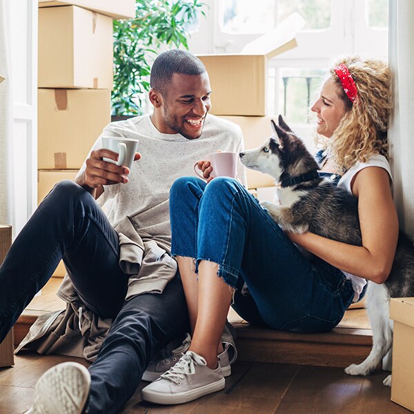 couple with their dog in a new home