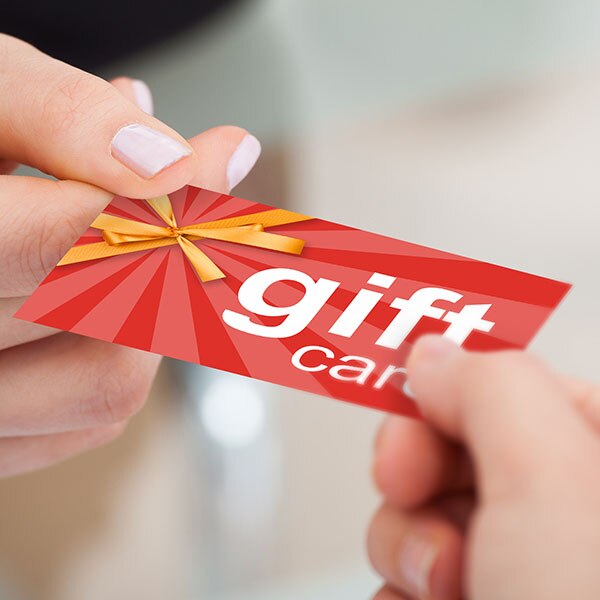 Hands holding a red gift card