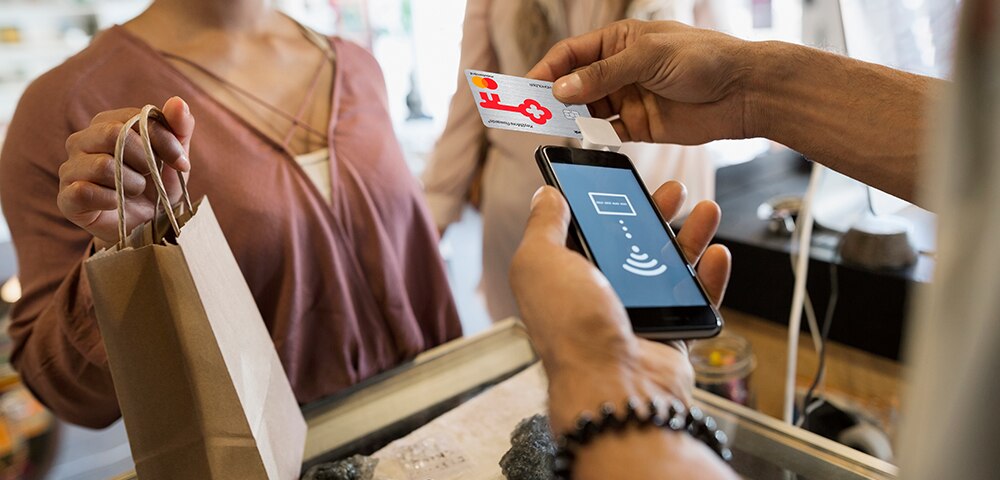 Woman using KeyBank card to pay
