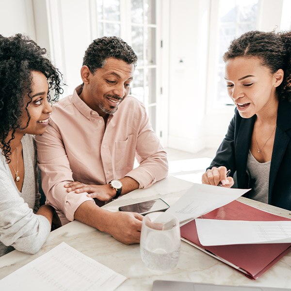 african-american couple reviewing documents with an african-american woman