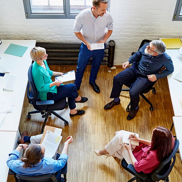 Business people sitting in chairs talking