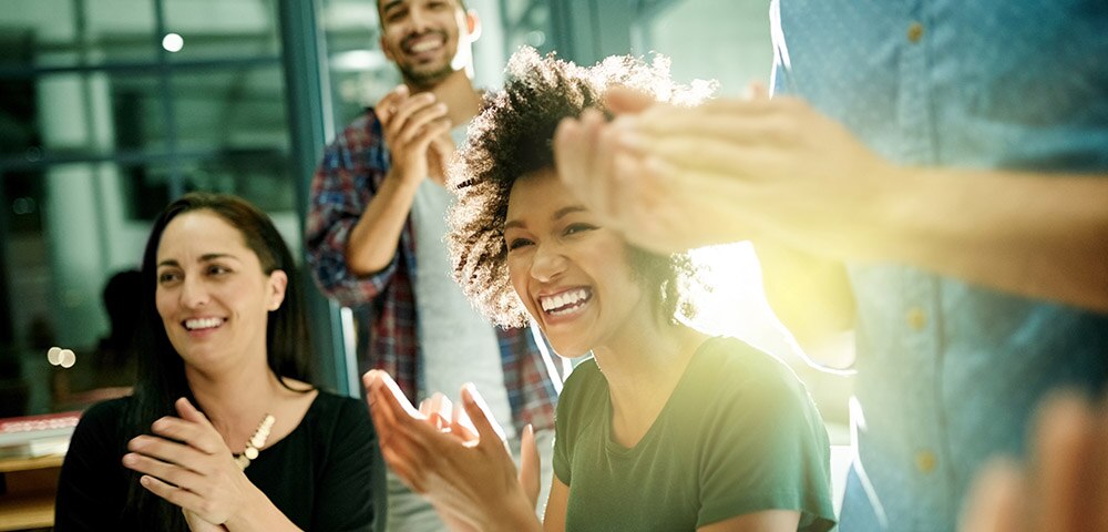 People in a meeting clapping