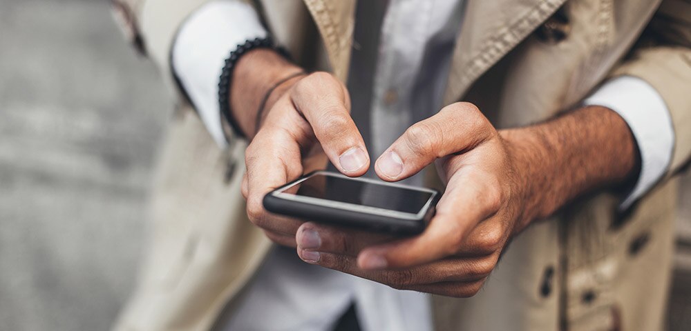 Hands holding a mobile phone