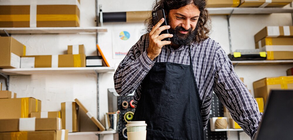 Man on phone in front of computer