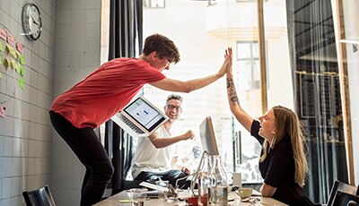 coworkers high-fiving in celebration