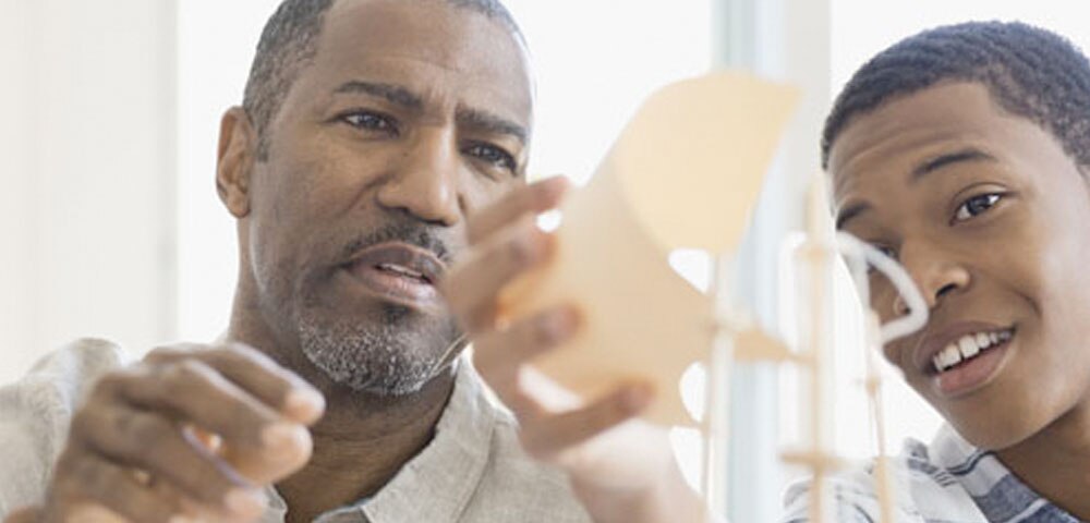 father and son building a model boat