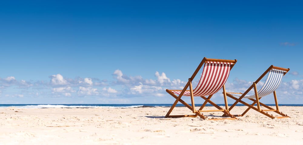 two beach chairs on the sand