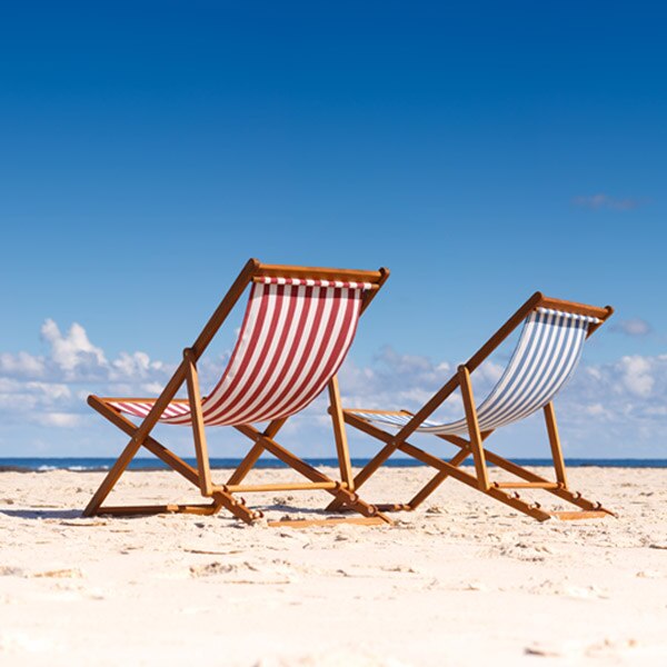 two beach chairs on the sand