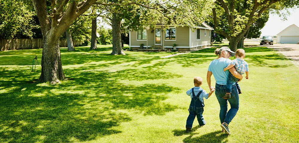 Mother walking with children on sunny day
