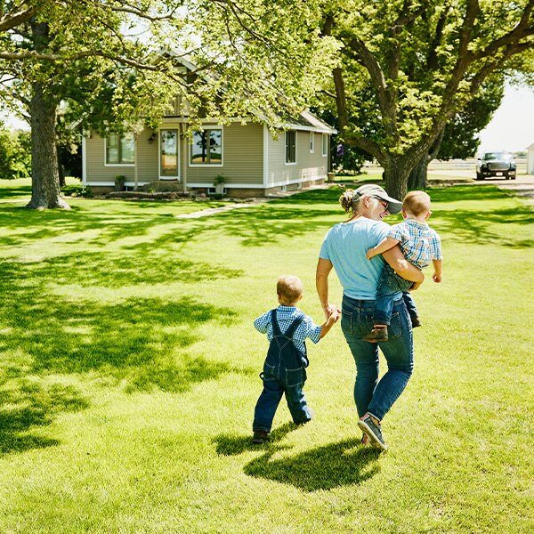 Mother walking with children on sunny day