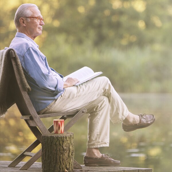Man sitting in a chair on a dock